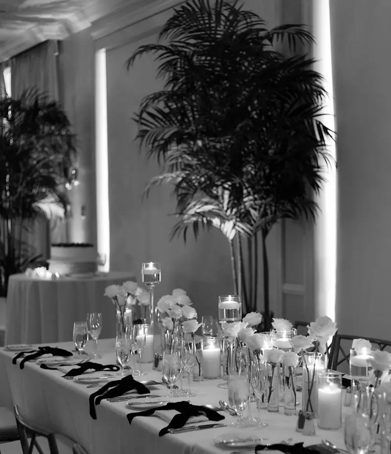 Black-and-white photo of a candlelit reception table at Katherine & Brad's wedding